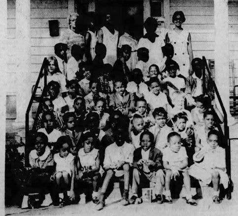 Large group of children sitting on steps