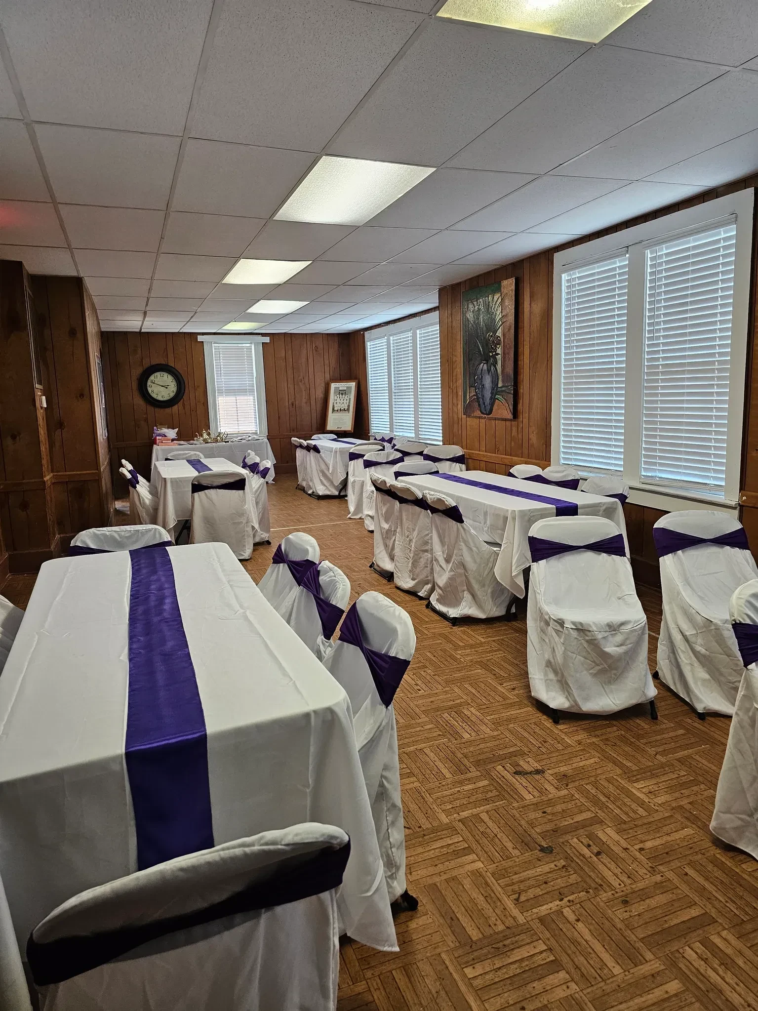Event room set with white and purple linens at the Sunlight Community Center